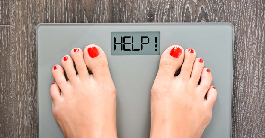 feet on a scale, with digital message "HELP!"